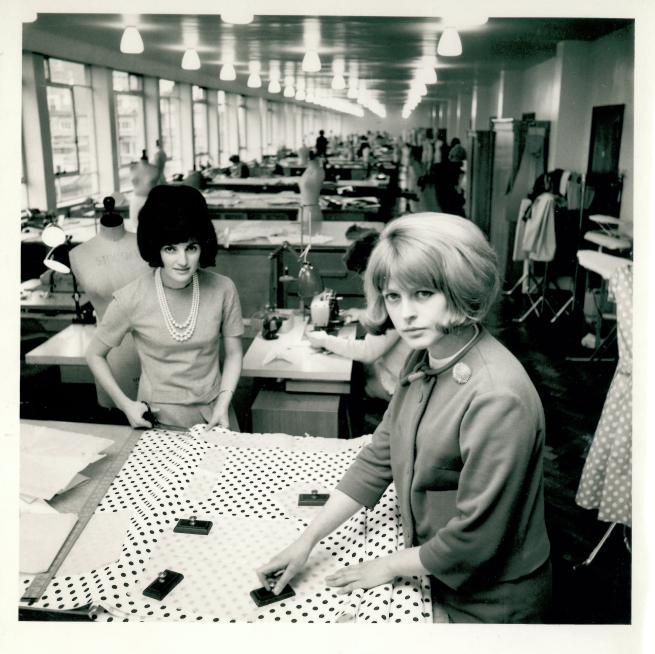 A black and white photo of two women working in a design studio.