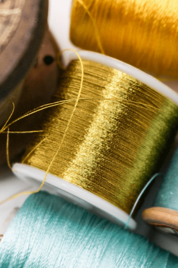 Gold and blue reels of thread