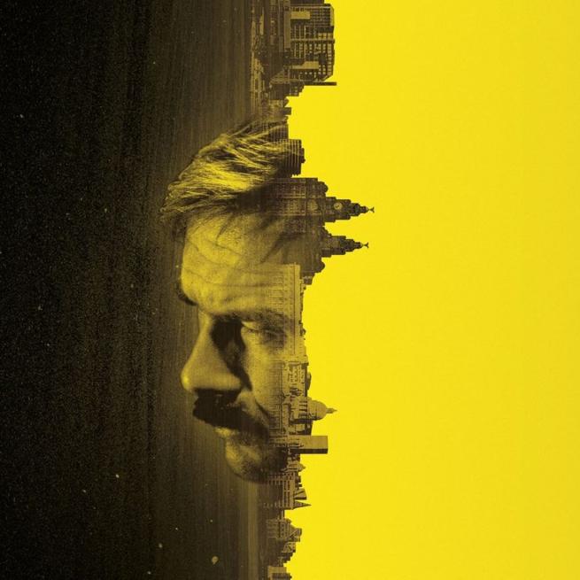 Image of a man's face super imposed on to a city skyline that appears vertically. Instead of the sky, yellow block colouring sits in its place.