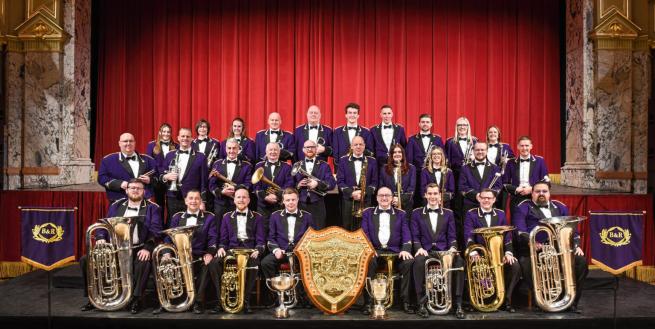 A brass band performing on a stage. 