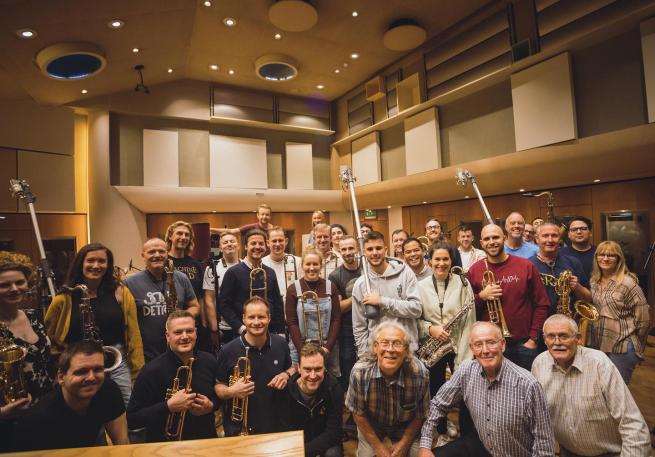 Photo of all the members of Doncaster Jazz Orchestra Alumni Band at a rehearsal, some with instruments