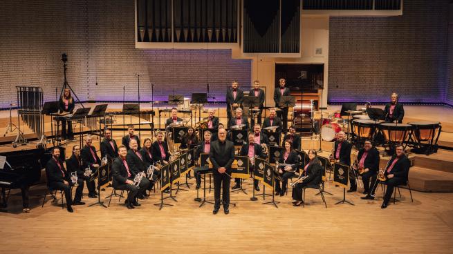 A brass band performing on a stage. 