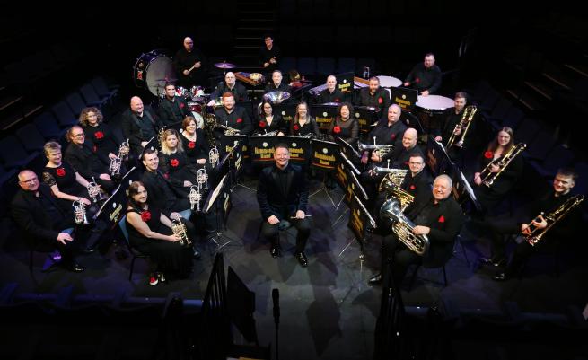 A brass band performing on a stage. 