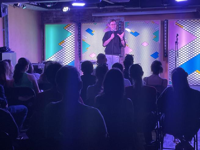 A standup comedian in front of an audience