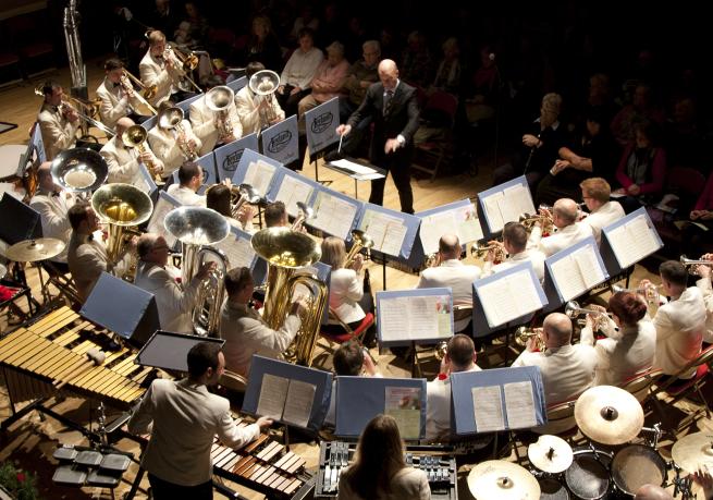 A brass band performing on a stage. 