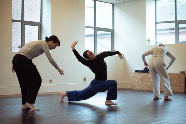 3 mid twenty, white, females dancing an brightly lit dance studio