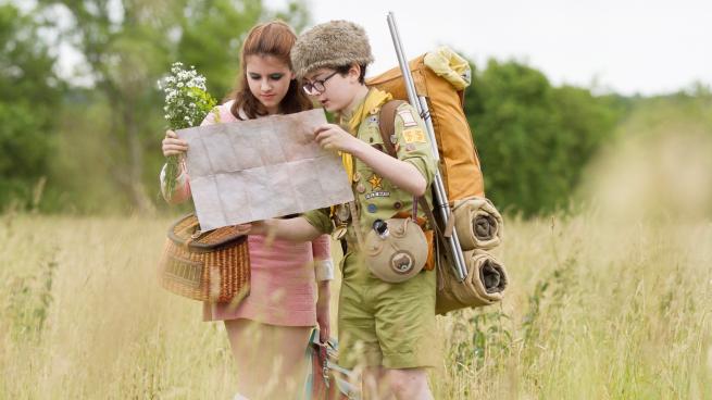 A still from Moonrise Kingdom featuring Suzy and Sam (played by Kara Hayward and Jared Gilman) reading a map together.