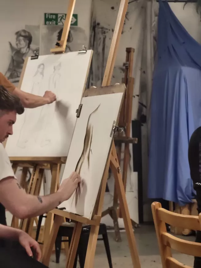 Artists drawing at their easels