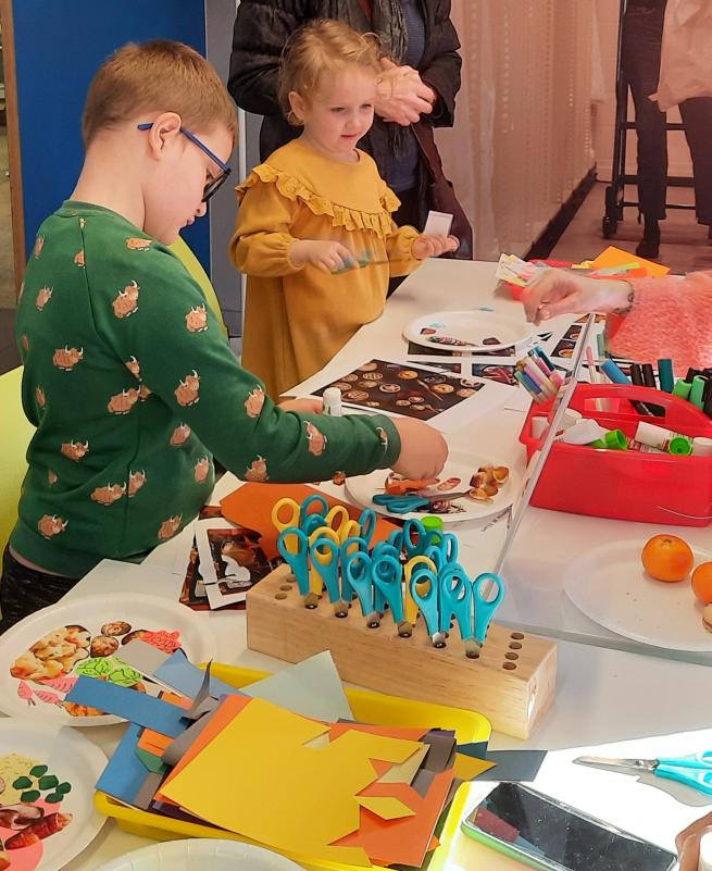 A colour image of two children at a craft table