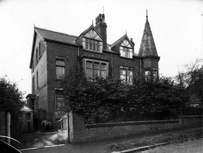 Black and white photograph of a large Victorian suburban house