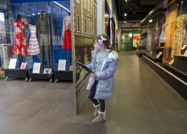 A colour photo of a child in a museum exhibition.