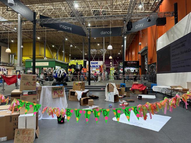 Den building with Cardboard boxes and white sheets in Kirkgate Market event space