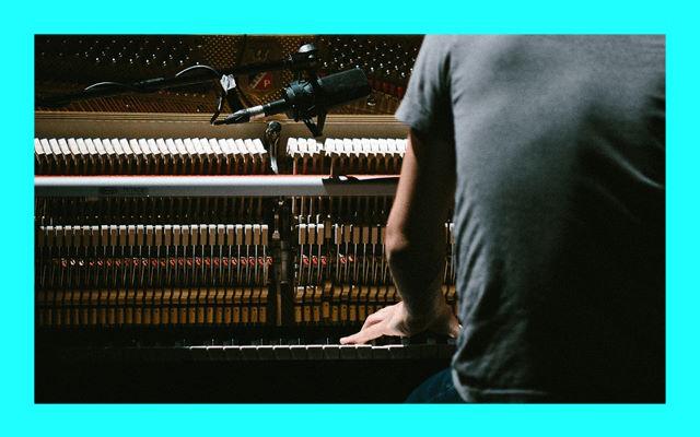 The back of someone playing the piano.