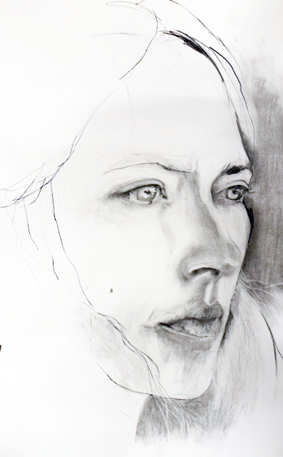 A  close up charcoal drawing  of a woman