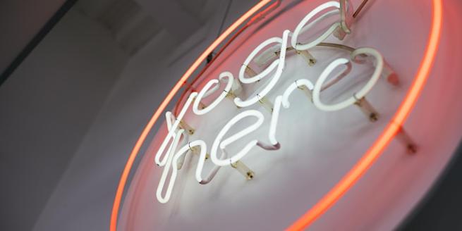 Yoga Hero branded neon light in white and peach