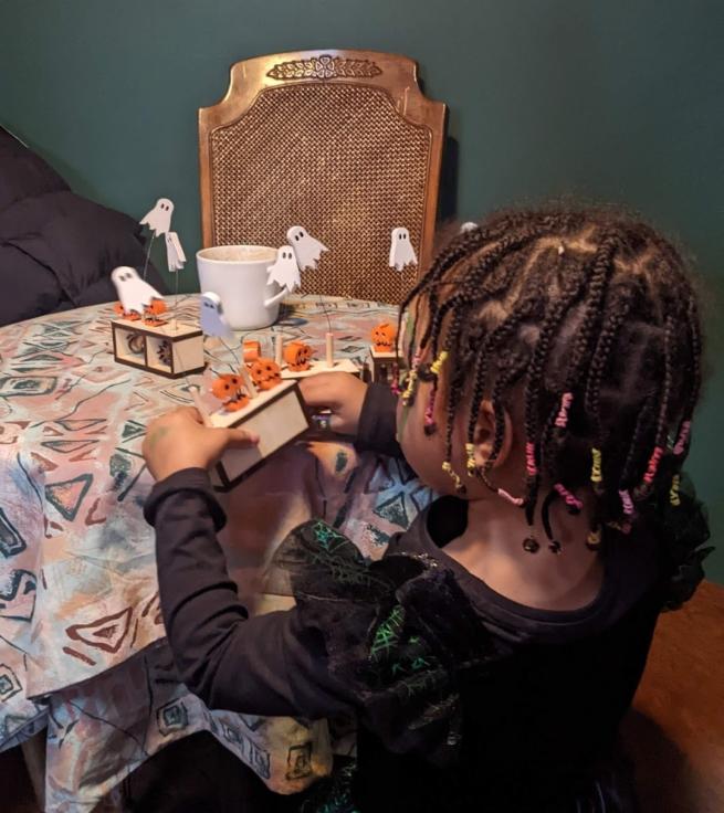 A child playing with a spooky themed automaton