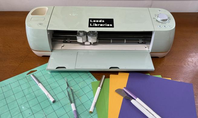 Cricut machine with pens and paper