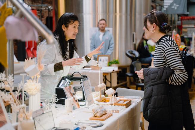 Maria from Maria Lau Bonded Jewellery serving a customer at a previous Mindful Market