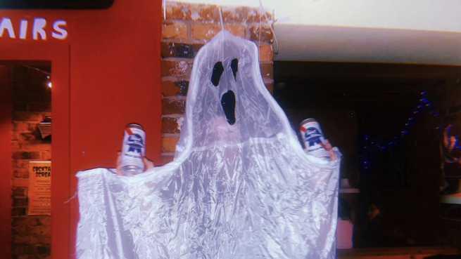 A spooky ghost with two cans of beer.