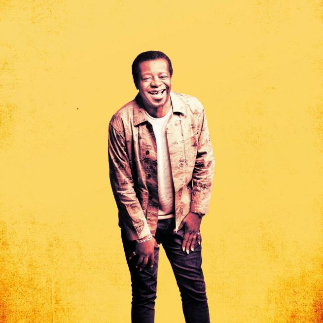 Image of Stephen K Amos wearing a brown jacket laughing with an illustration filter on.