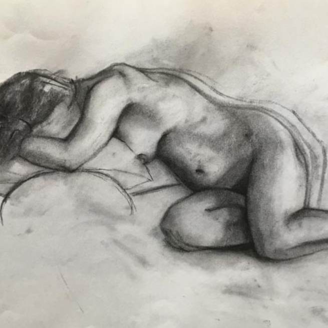 Charcoal sketch on white paper of a nude female figure laid on her side