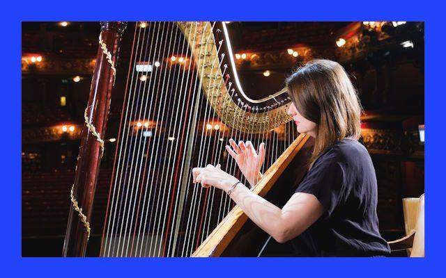 A woman playing the harp.