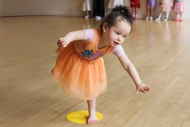 A young girl balances on a spot