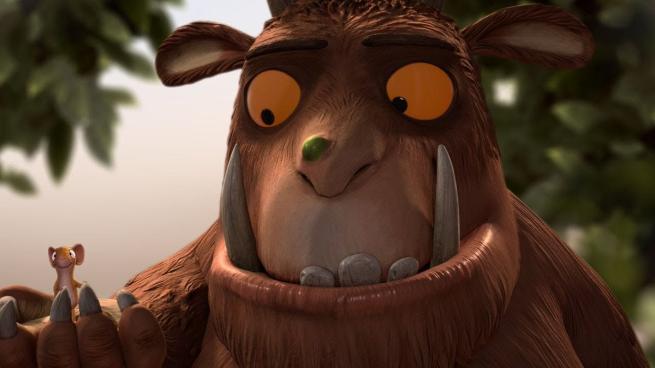 The Gruffalo holds Mouse in his hand 