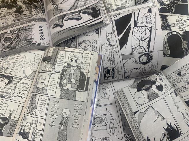 The whole frame of the photo is filled with various open manga comic books