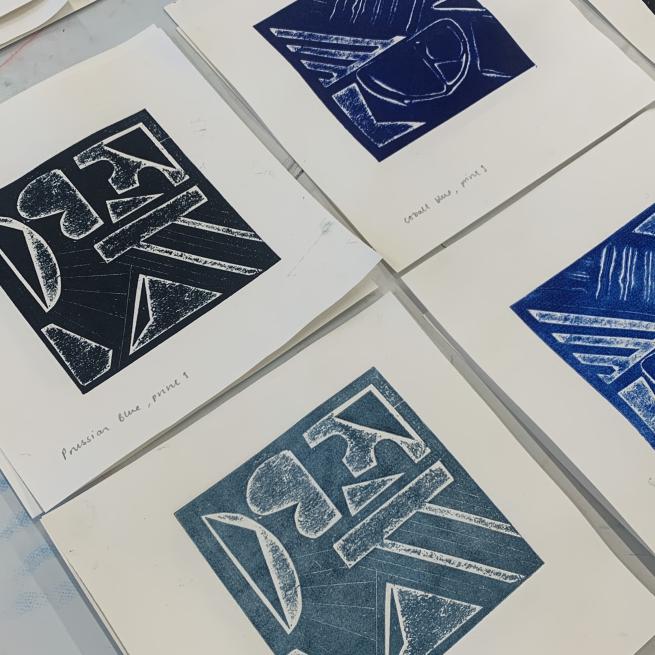 4 prints in flat lay formation, all created using different shade of blue ink.