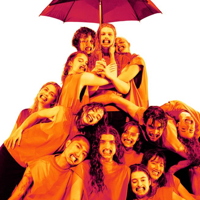 A group of dancers under an umbrella with a bright orange filter