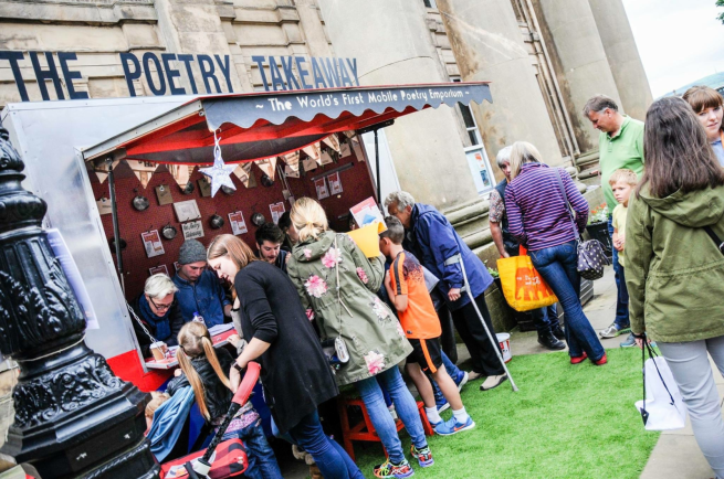 People gathered round the Poetry Takeaway stall