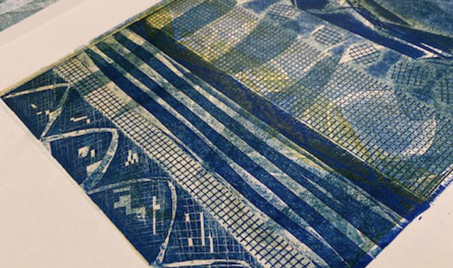 An abstract printed image in blues and yellows featuring various patterns and shapes