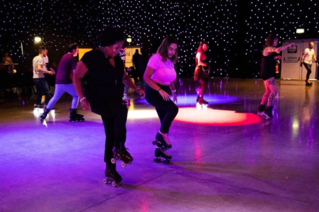 A group of dancers wearing roller skates