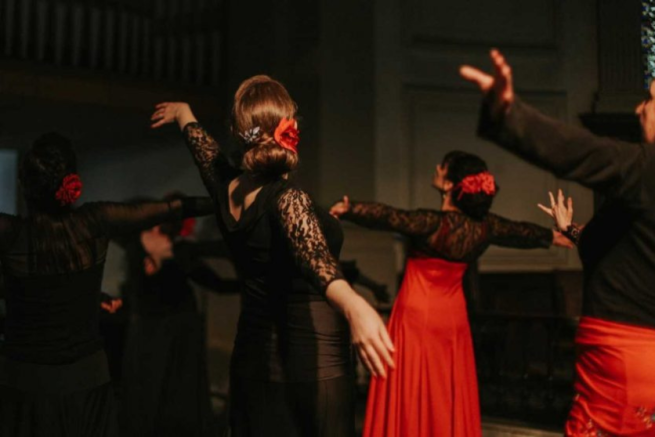 A group of dancers with outstretched arms