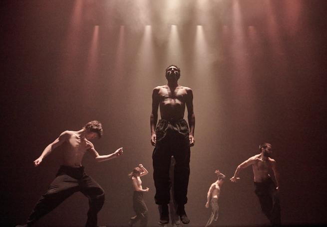 Dancers in motion under atmospheric lighting