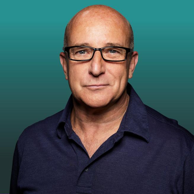 Image of Paul McKenna from the shoulders up wearing glasses.