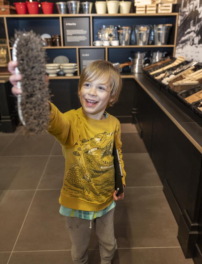 A child holding a scrubbing brush in the M&S Archive