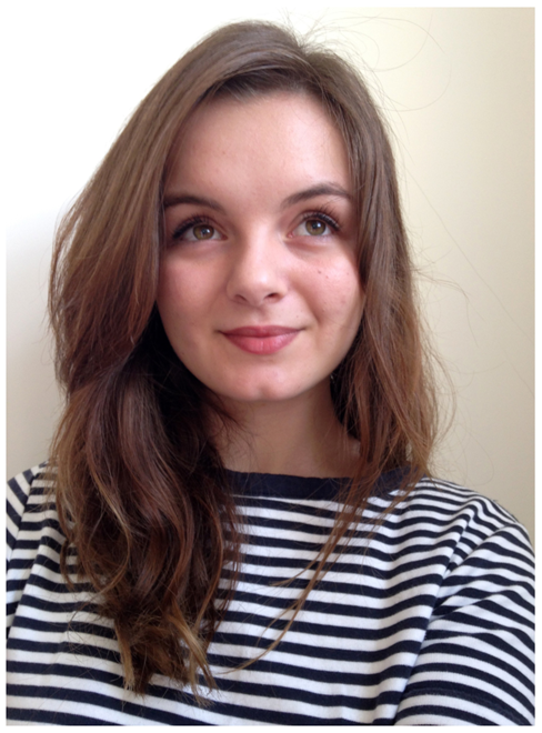 A photographic portrait of author Bethan Woollvin wearing a stripy top.