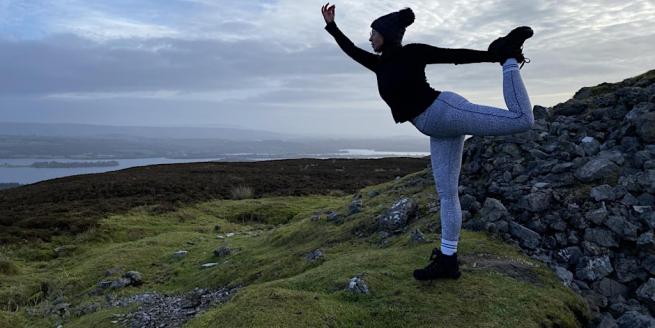 Yoga teacher Bryony in Dancer pose in the countryside