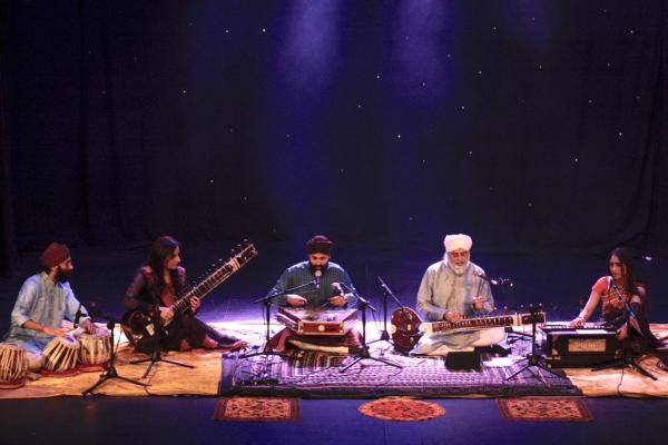 People on stage playing Indian Classical instruments