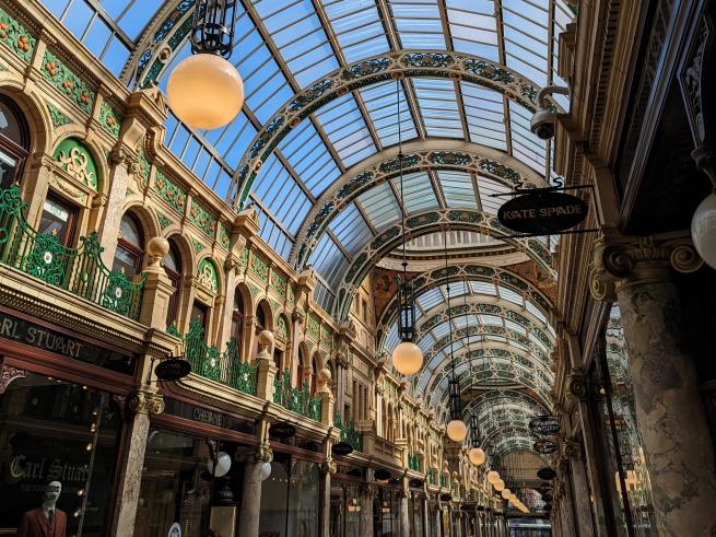 Inside the ornately decorated County Arcade, with glass roof, shop frontages and late Victorian architecture