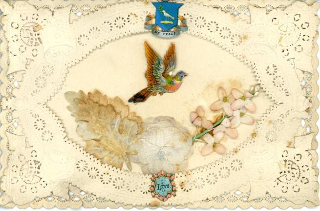 A lace greetings card with an embroidered bird on it