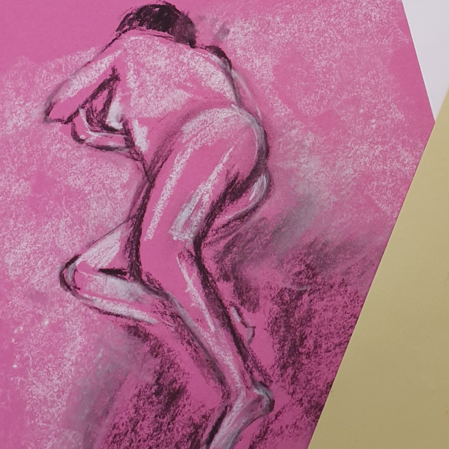 Black and white charcoal drawing on pink paper of a nude figure laid down.