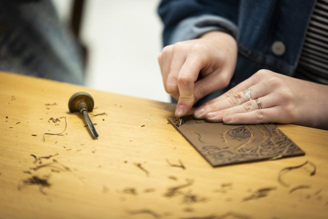 Lino cutting tools on wooden table. 