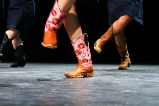 People in cowboy boots dancing