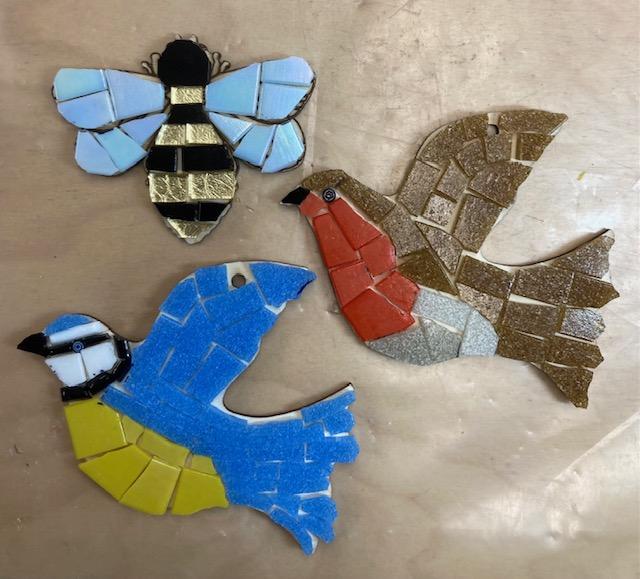 Mosaics of a bird, robin and bee.