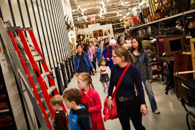 Families walking around the object store at Leeds Discovery Centre. 