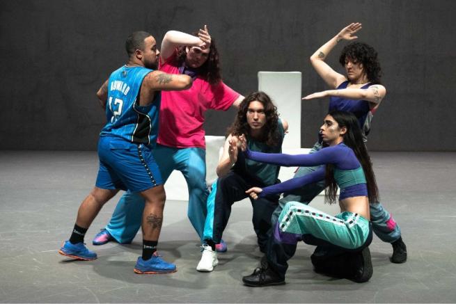 A group of dancers in interacting poses