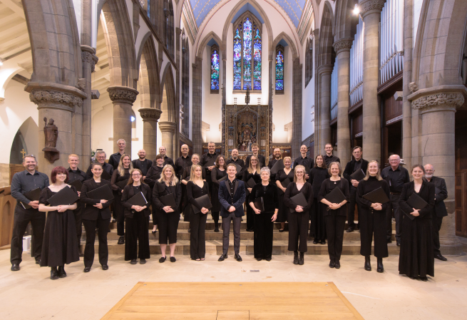 A chamber choir standing in a church.